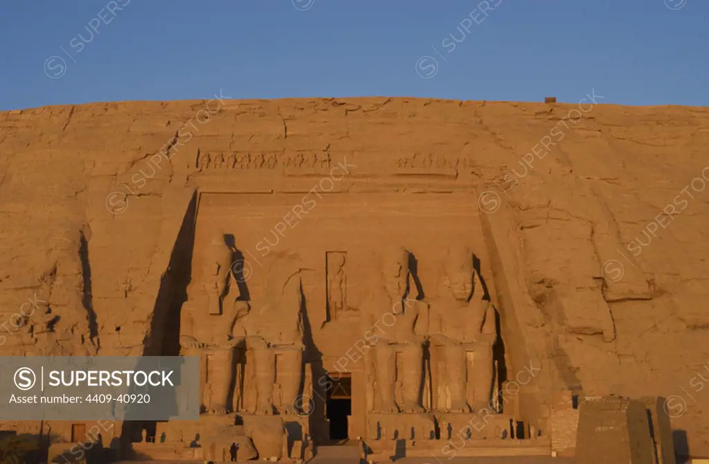 Egyptian art. Great Temple of Ramses II. Four colossal statues depicting the pharaoh Ramses II (1290-1224 BC) seated with the nemes head and surmounted by the double crown. 19th Dynasty. New Kingdom. Abu Simbel. Egypt.