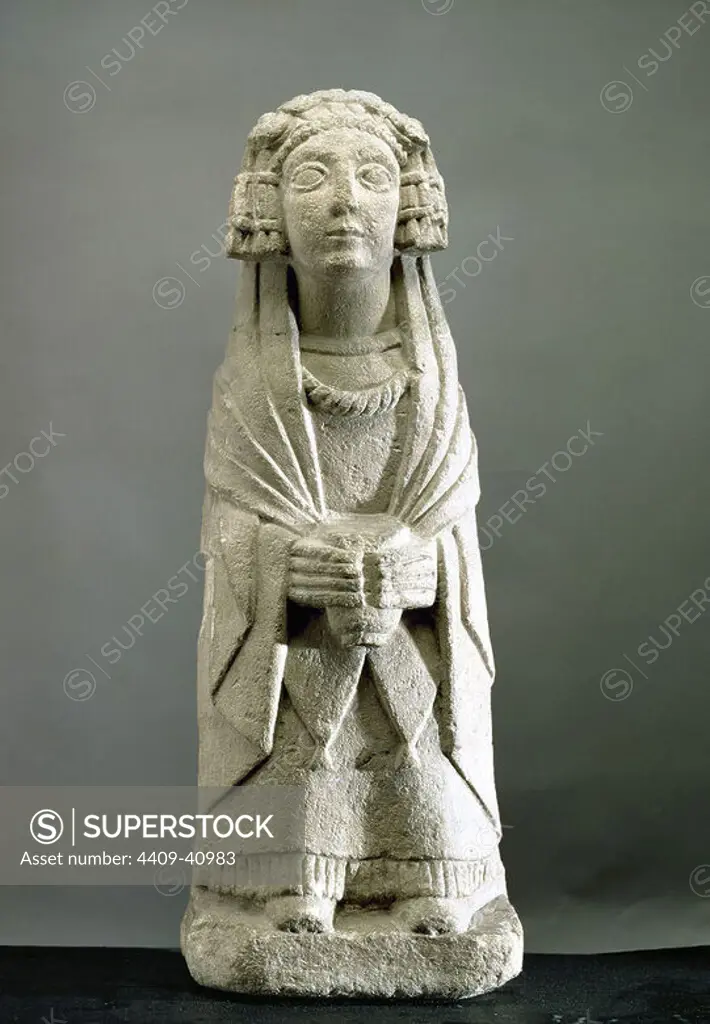 Iberian sculpture. Sculpture of Dama Oferente (Lady Making an Offering), with a glass between the hand. Sandstone. This is one of the sculptures found in the Cerro de los Santos, Montealegre del Castillo, provincia de Albacete, Spain. Cerro de los Santos was where a shrine used between the 4th century BC and the Roman period was discovered in the middle of 19th century. National Archaeological Museum, Madrid, Spain.