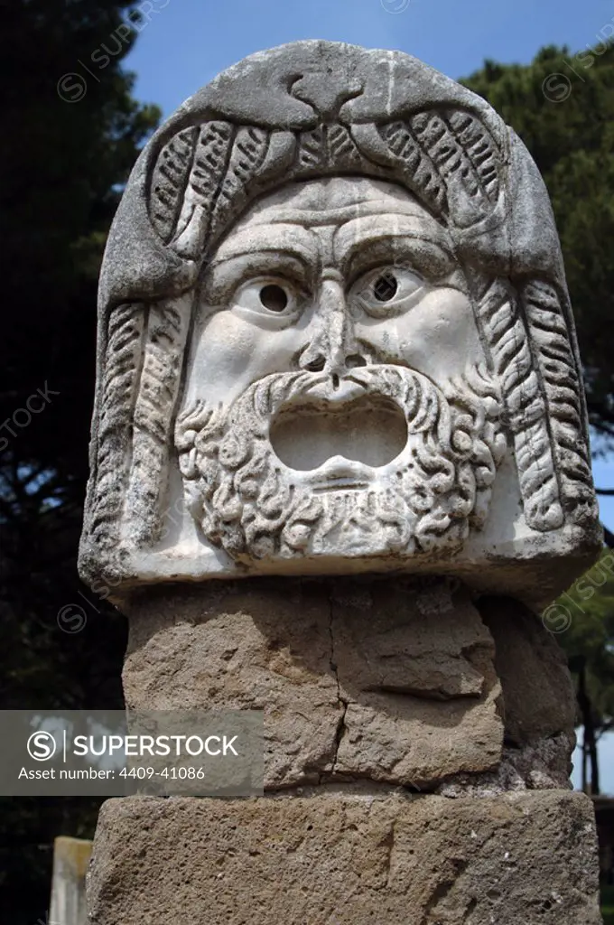 Ostia Antica. Roman theatrical mask on the stage of the Theatre. Marble. 1st - 2nd centuries BC. Italy.