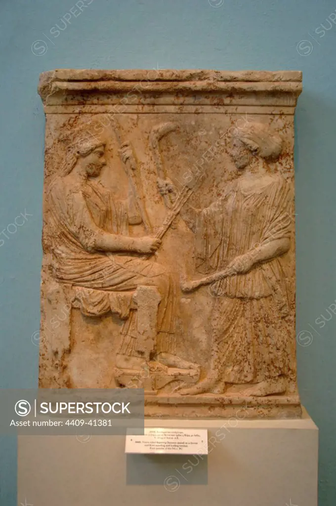 GREEK ART. GREECE. Votive relief representing Demeter sitting on a throne and kore standing holding torches. Dated in the first quarter of s.V b.C. Museum of Eleusis. Athens. Greece.