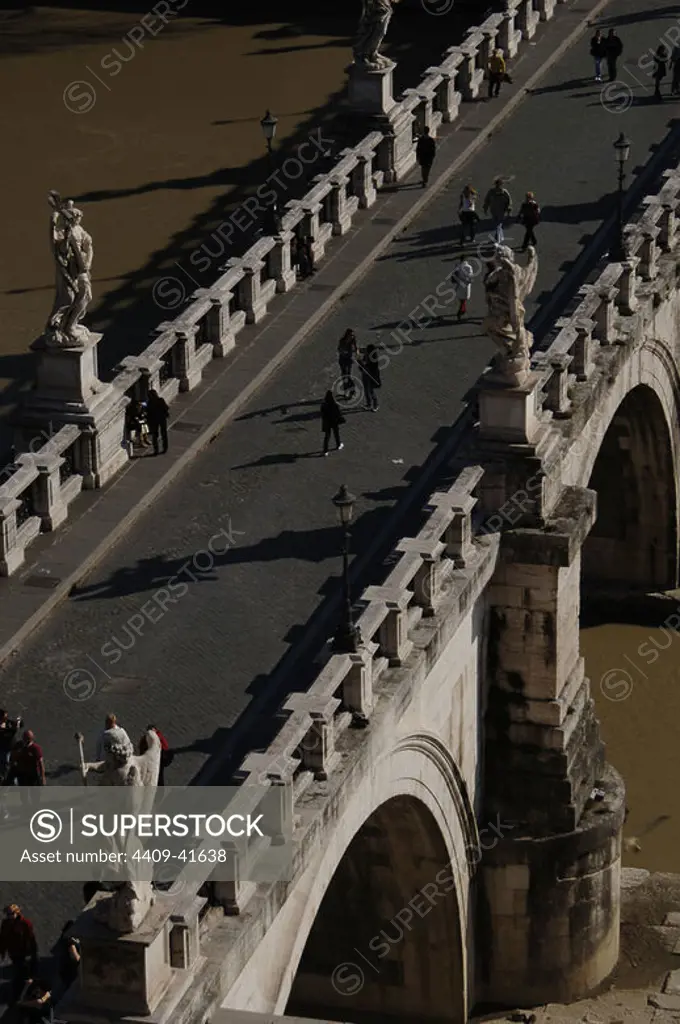 Italy. Rome. People crossing Saint Angelo Bridge (1668-1671) over the Tiber river. Aerial view.