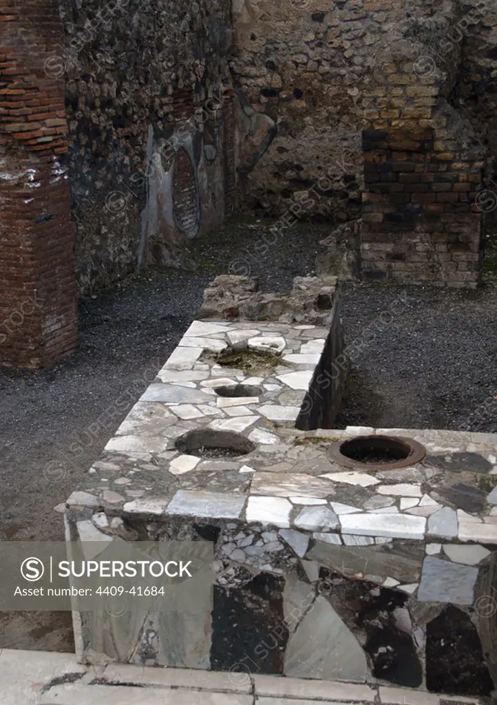 Italy. Pompeii. Marble covered counter Thermopolium. Campania.
