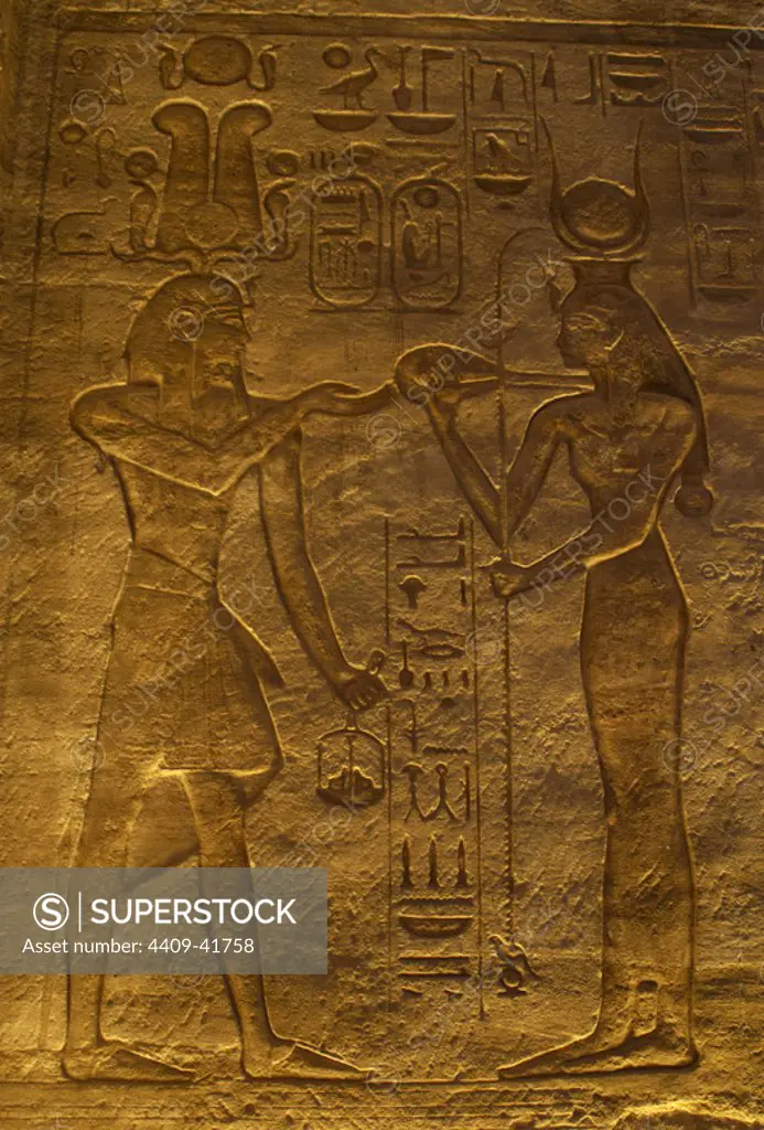 Egyptian art. Great Temple of Ramses II. Pharaoh Ramses II before a goddess. 19th Dynasty. New Kingdom. Abu Simbel. Egypt.