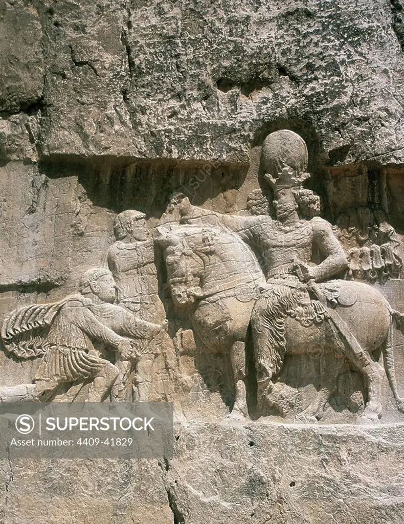 Iran. Naqsh-e-Rustam. Necropolis. Sassanid period. The triumph of Shapur I (241-272) (on horseback). Shapur's victory over Roman emperors Valerian (kneeling) and Philip the Arab.