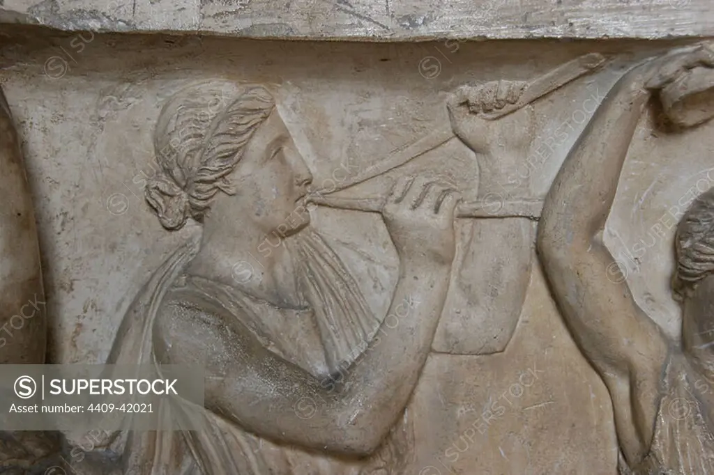 Roman Art. Woman playing double flute "Aulos". Relief. Detail of sarcophagus. Vatican Museums. City of the Vatican.