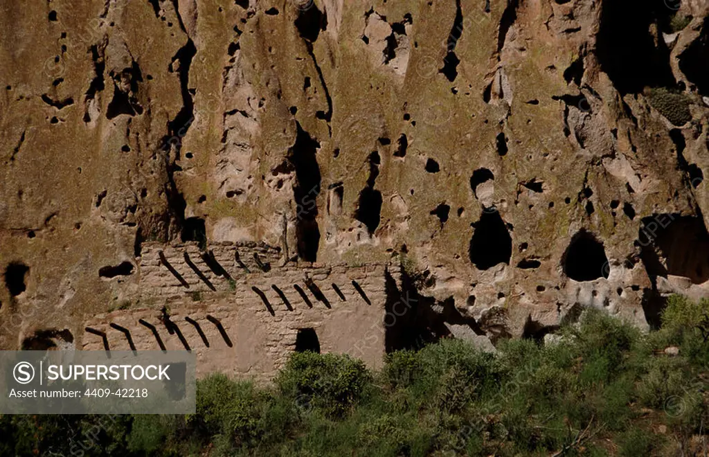 USA. Near Los Alamos. New Mexico. Bandelier National Monument. Multistory dwellings of Ancestral Pueblo People. Rock wall foundations and beam holes carved into tuff.