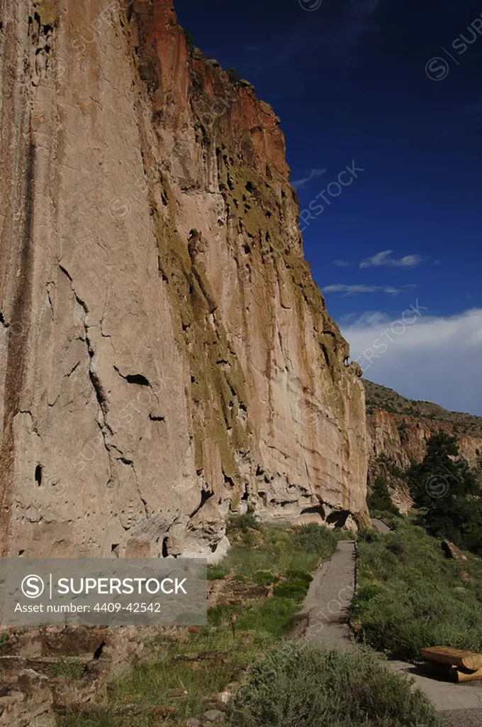 USA. Near Los Alamos. New Mexico. Bandelier National Monument. Multistory dwellings of Ancestral Pueblo People. Rock wall foundations and beam holes carved into tuff.