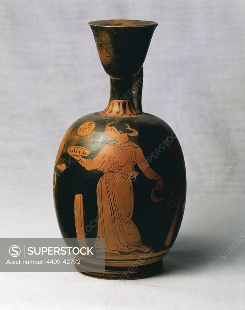 Art Greek. Magna Graecia. Greek vase painting. Red figure pottery. Lekythus. Used for storing oil. Decoration. Woman with cake votive and tambourine addressing a altar. Comes from Taranto. Italy. Museum of Perfume. Barcelona. Spain.