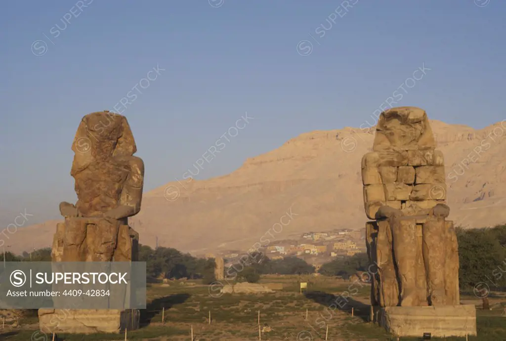 Colossi of Memnon. Stone statues depicting pharaoh Amenhotep III (14th century B.C.) in a seated position. Panoramic view. Eighteenth Dynasty. New Kingdom. Luxor. Egypt.