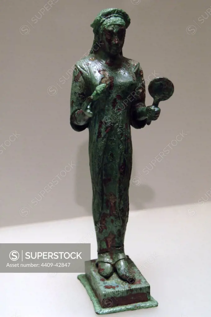 Roman art. Lavinium. Bronze votive objects from the santuary of the 13 altars. Statuette of female figure (kore). Baths of Diocletian (Roman National Museum). Rome, Italy.