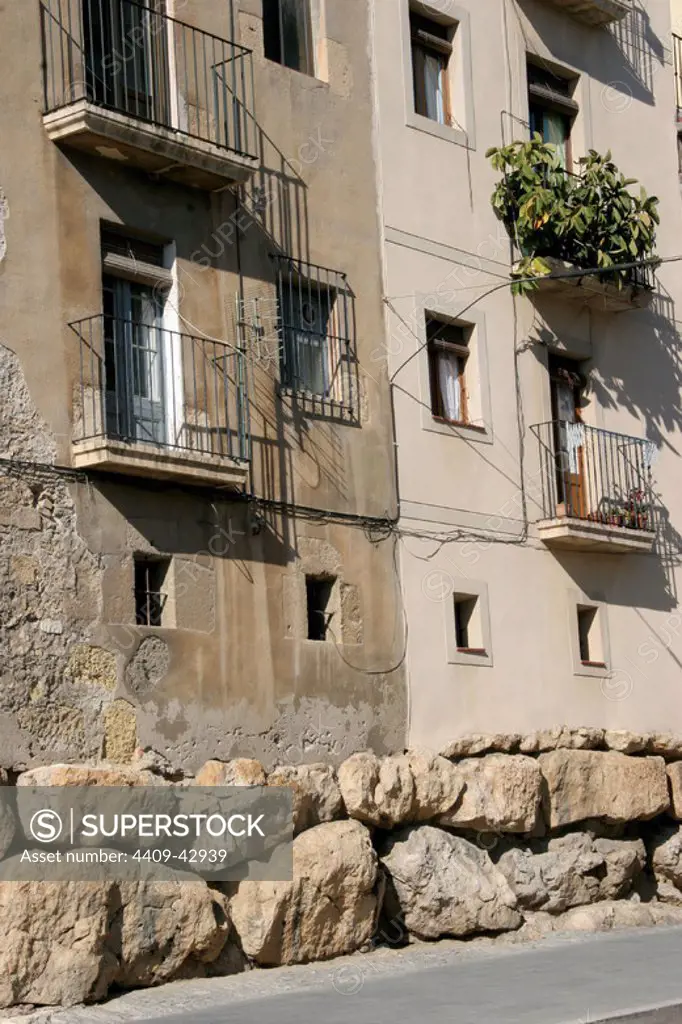 Spain. Catalonia. Tarragona. Houses in the old town. At the botton, the remains of the roman cyclopean wall.