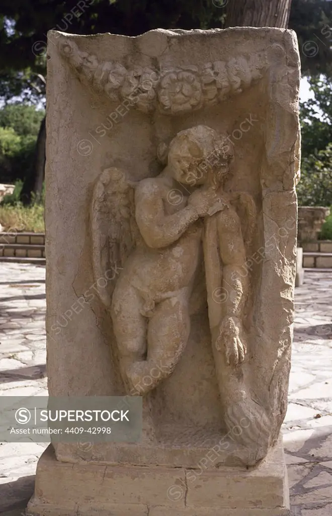 Cupid. Classical Mythology. Good of desire. Relief of Cupid with torch burning passion. Roman Art. Maktar. Tunisia.