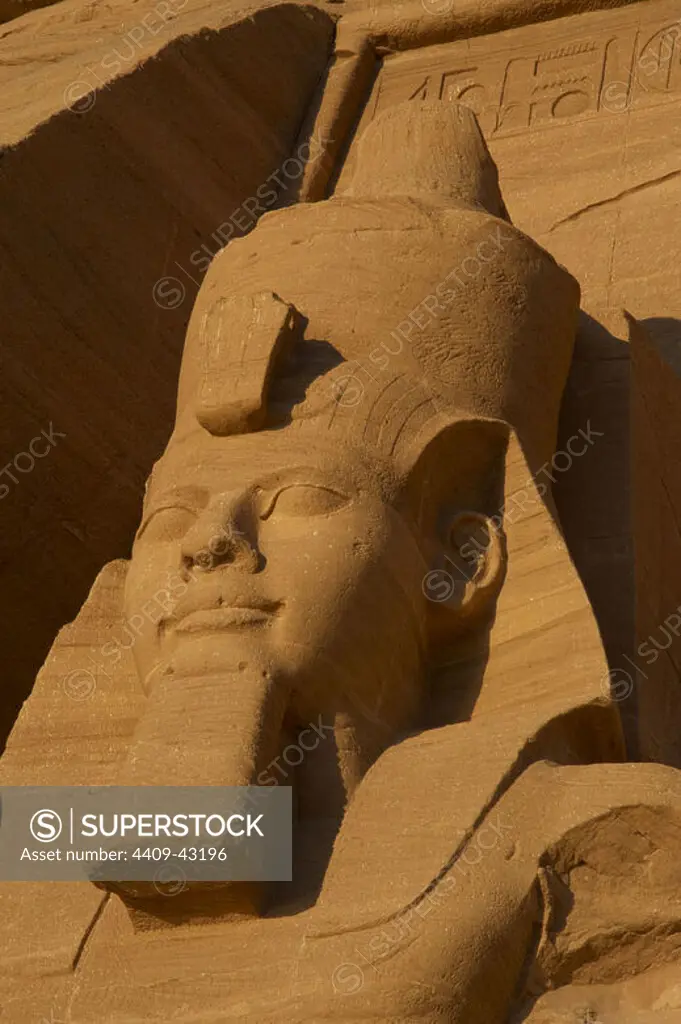 Egyptian art. Great Temple of Ramses II. Colossal statues depicting the pharaoh Ramses II (1290-1224 BC) seated with the nemes head and surmounted by the double crown. 19th Dynasty. New Kingdom. Abu Simbel. Egypt.