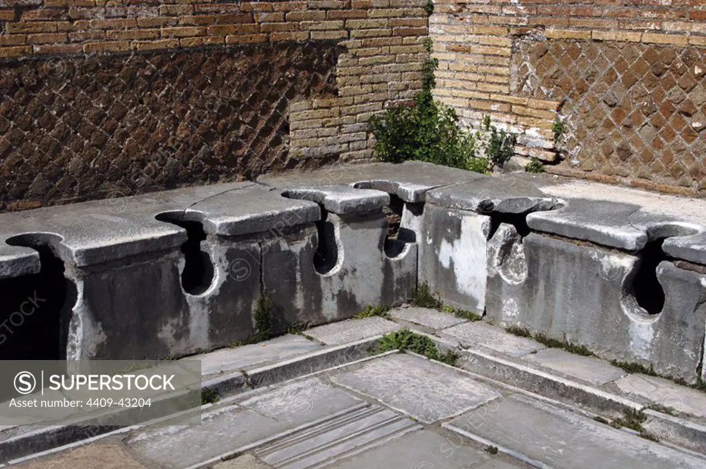 Ostia Antica. Latrine at the Domus of Triclini, headquarters of the guild of builders. 2nd century AD. Near Rome.