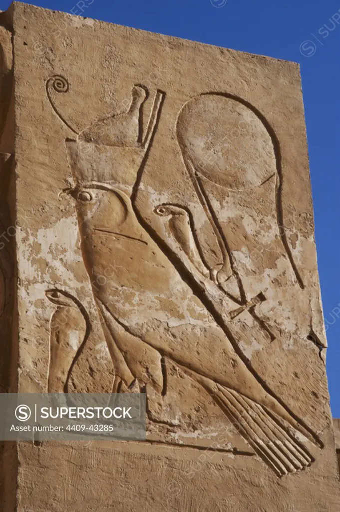 Relief with an inscription in hieroglyphics. Solar disk with snake (cobra) with the ankh around his neck and Falcon with double crown over a cobra. Temple of Hatshepsut. 18th Dynasty. New Kingdom. Deir el-Bahari. Egypt.