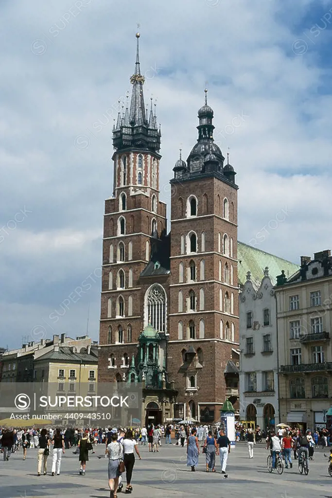 POLAND. KRAKOW. View of the Central Market Square with Saint Mary Church founded in 1222 by the Bishop of Krakow Iwo Odrowaz and destroyed by the Tartars in 1241.The actual building was built between 1345 and 1408 with two towers of the fourteenth century with later additions in different styles.
