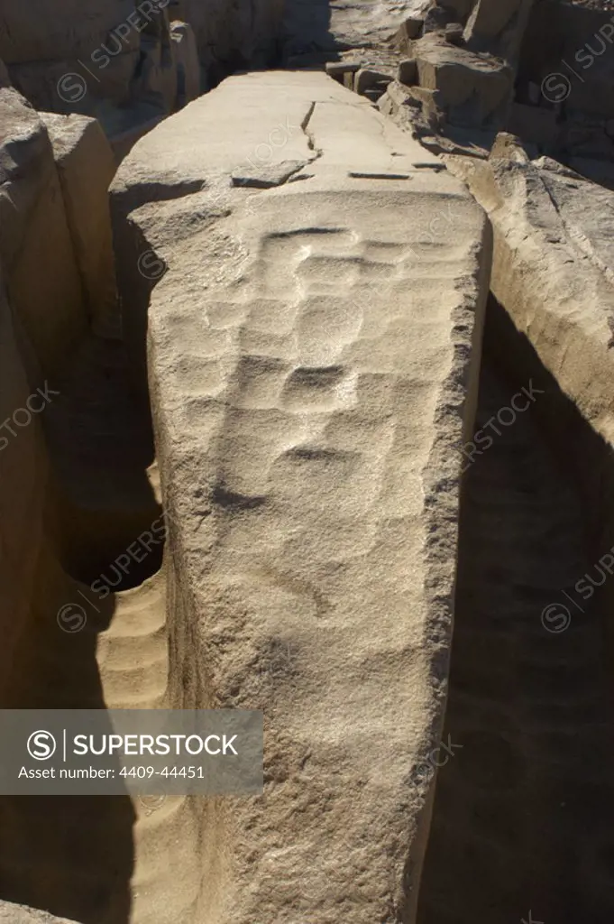 Egypt. Aswan. The unfinished obelisk in a granite quarry. The bottom side is still attached to the bedrock and it presents the marks from workers' tools.