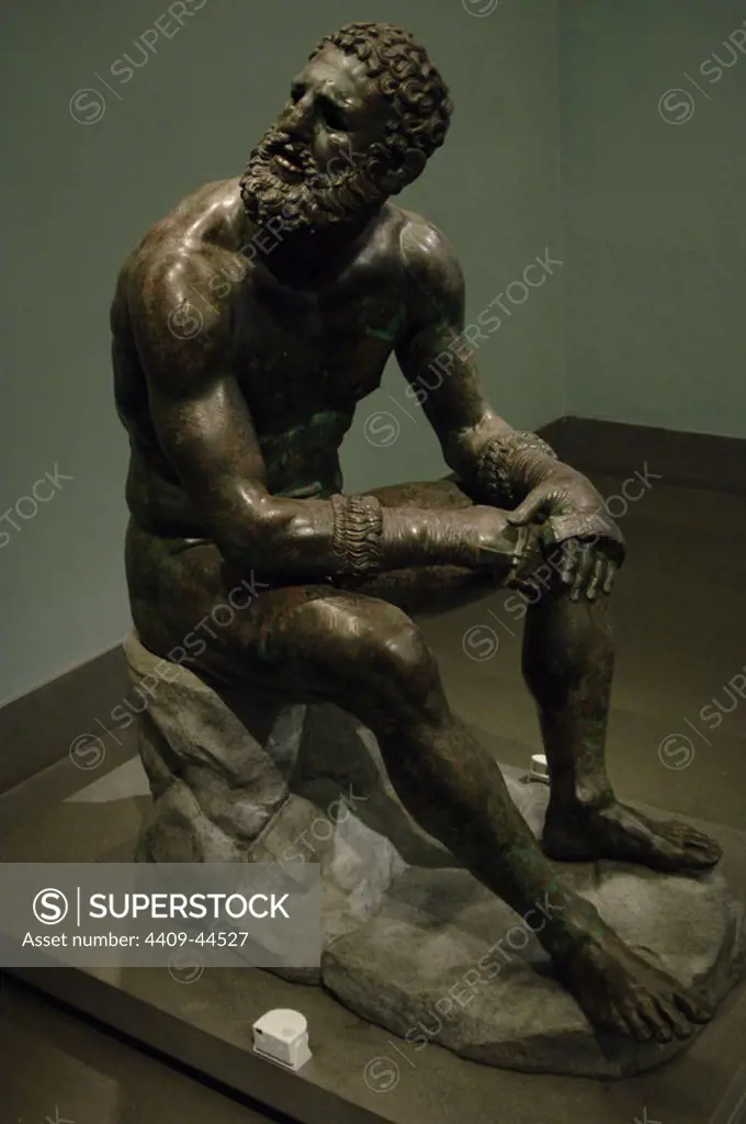 Greek Art. Hellenistic. Boxer of Quirinal or the Terme Boxer. Bronze sculpture of the Hellenistic period (1st century B.C.). Boxer sitting at rest, with metal and leather dressings used for combat. Palazzo Massimo. National Roman Museum. Rome. italy.