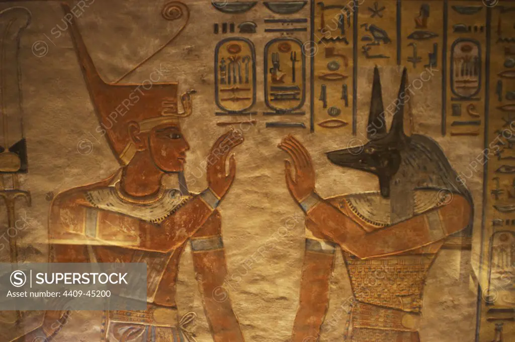 Tomb of Amen Khopshef, son of Ramses III. Polychrome reliefs decorating the walls of the burial chamber. God Anubis on the right. Twentieth dynasty. New Kingdom. Valley of the Queens. Egypt.