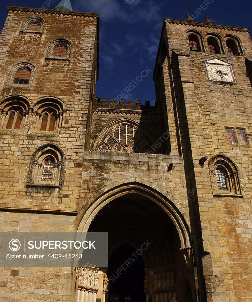 Portugal, Alentejo region, Evora. The Cathedral of Evora (Se de Evora). Declared a World Heritage Site by Unesco in 1988. Main facade. The main entrance portal over which a Gothic window with period tracery. This is flanked by two towers which were added in the 16th century. The Gothic doorway is worthy of note for its Gothic sculptures of the twelve apostles, six on each side of the entrance, which were added in the early 14th century.