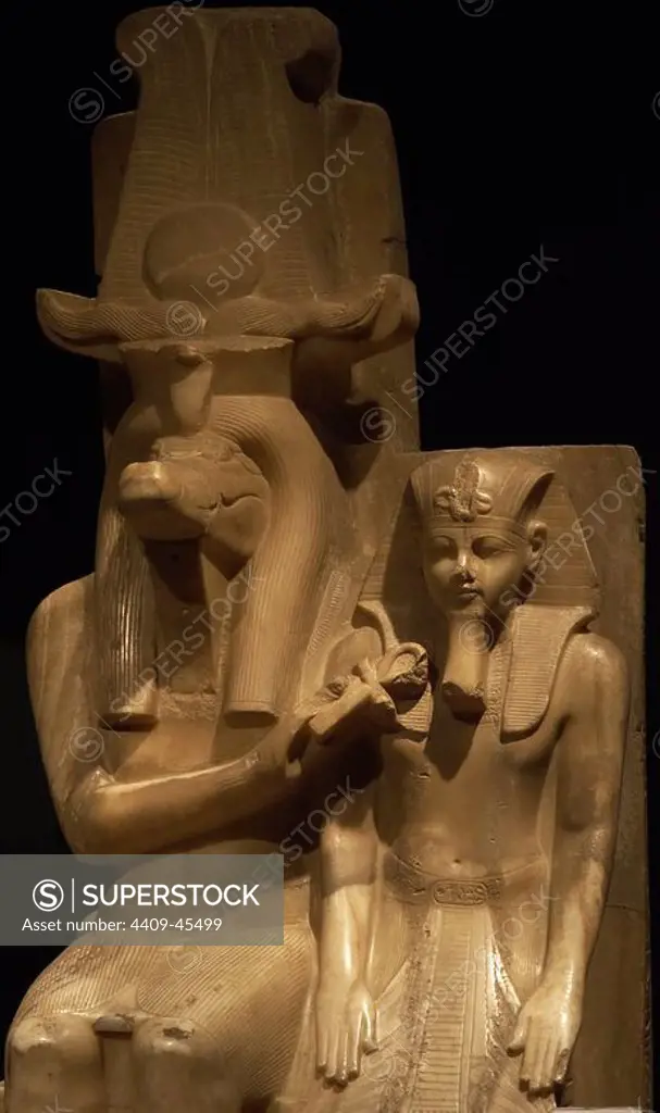 Statue of Amenhotep III (Neb-Maat-Ra) and Sobek c.1390-1352 BC. Carved from Calcite (Egyptian Alabaster). Found in the Sobek temple at Dahamsha. Sobek is seated in a human form with the crocodile head and his right hand holds the Ankh giving life to the youthful Amenhotep III. The King is wearing the Nemes headdress, with the uraeus and royal beard. 18th Dynasty. New Kingdom. Luxor Museum. Egypt.