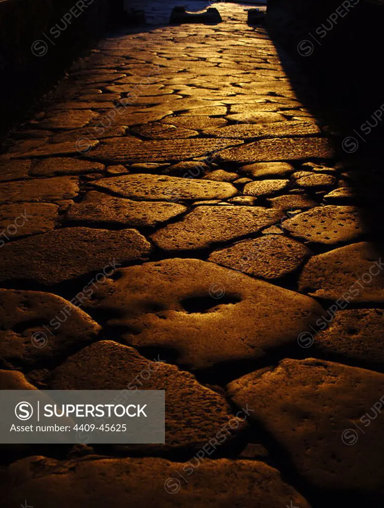 Italy. Pompeii. Sunset on a cobbled street.
