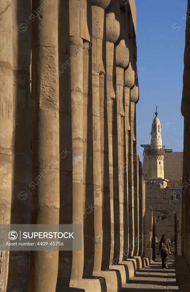 EGYPT. Luxor temple. Court of Amenhotep III composed by fasciculate columns with papyrus capitals. Dynasty XVIII. New Kingdom. The mosque of Abu El-Haggag in the background. Ancient Thebes. "Waset".