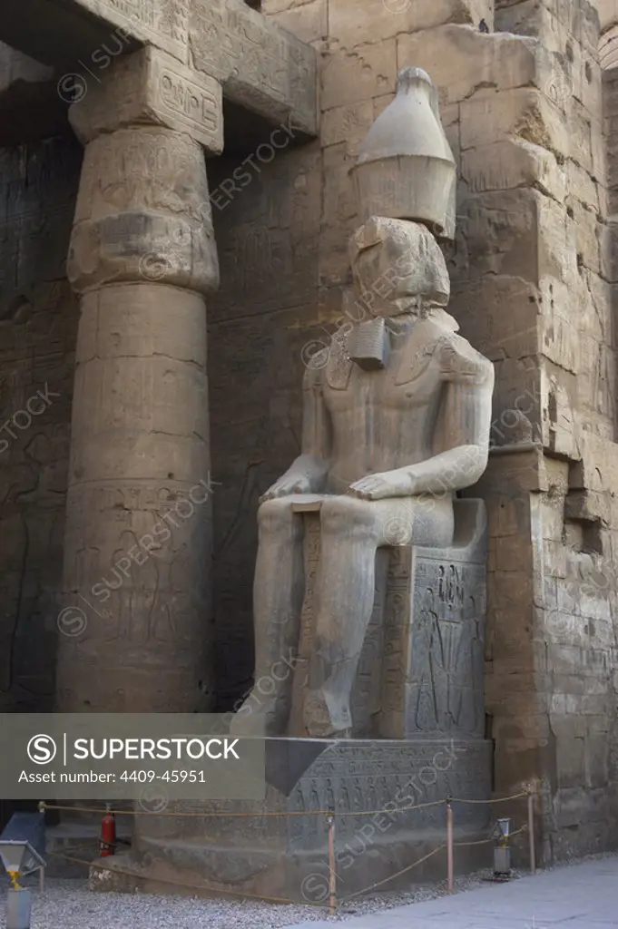 Statue of Amenhotep III (later usurped by Pharaoh Ramses II), between the columns holding the first courtyard. New Kingdom. Temple of Luxor. Egypt.