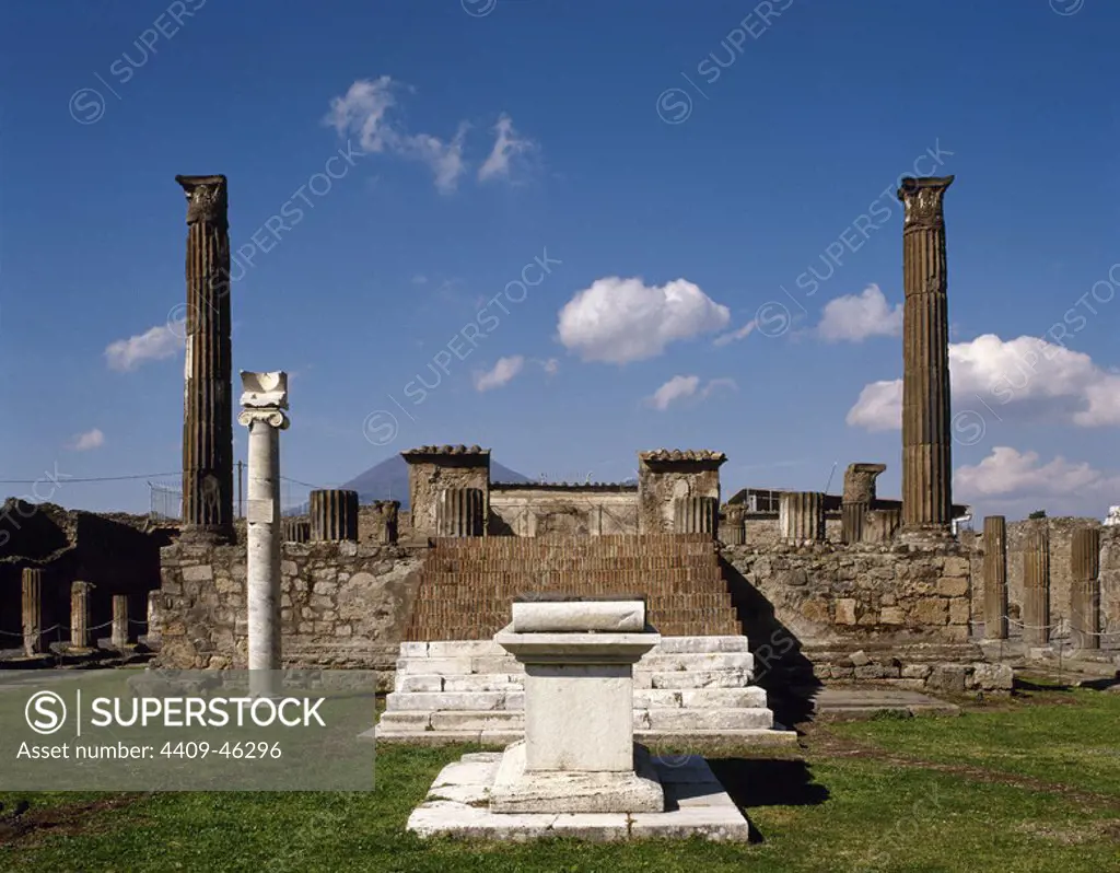 Italy. Pompeii. Temple of Apollo. Marble's altar and Ionic column built to hold the sundial. In the background. stairs and two fluted Corinthian columns.