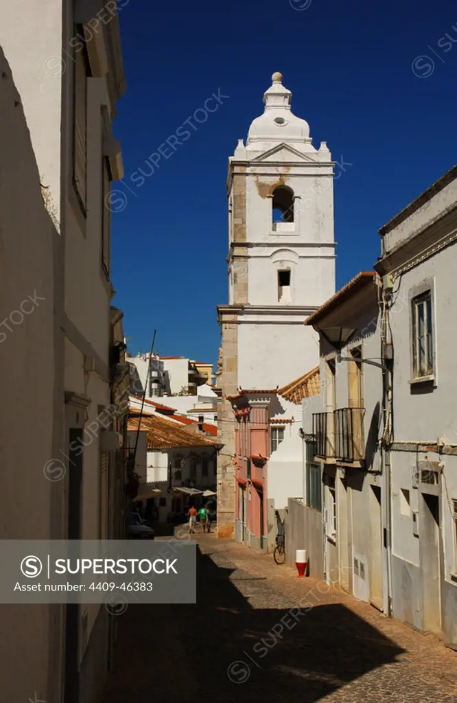 Portugal. Lagos. View of a street with the bell tower of the church of San Antonio, at background. Algarve.