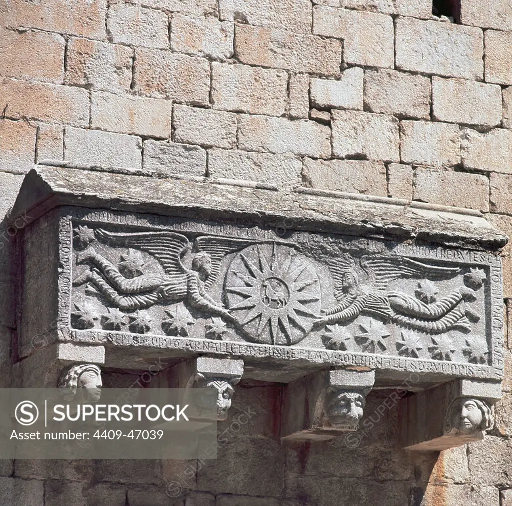 Early Christian art. St. Feliu Church. Limestone sarcophagus attached in the south wal. In his forehead represents two angels holding a sun in the center of which is the mystic lamb with the cross. Girona. Catalonia.