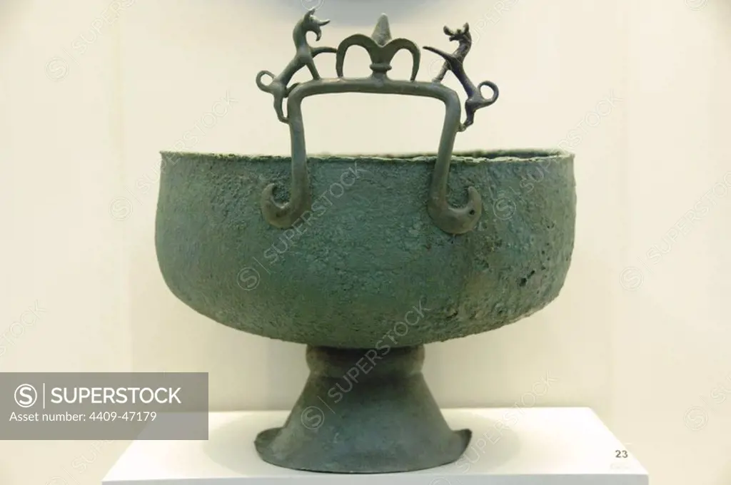 Greek Art. Archaic Period. 7th century BCE. Bronze bowl with globular body and a handle with two rampant lions facing each other and a flower in the middle. Archaeological Museum of Olympia. Greece.