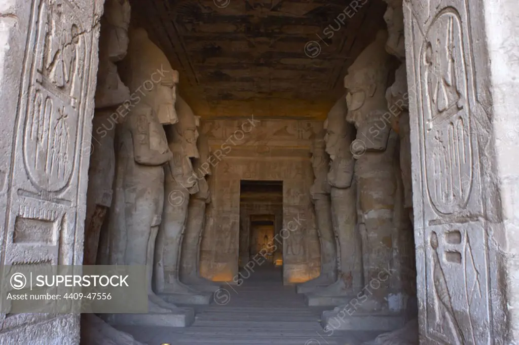 Egyptian art. Great Temple of Ramses II (1290-1224 BC). Funerary temple carved in the rock. View from inside the first room, with eight statues of Ramses II as the god Osiris. Abu Simbel. Egypt.