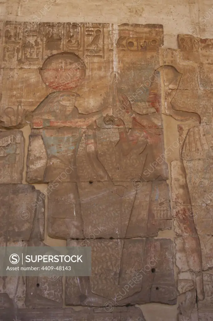 Egypt. Abydos. Temple of Seti I. New Kingdom. 19th Dynasty. The Pharaoh Ramesses II with Ra-Harakti (Horus of the Horizon). Second courtyard wall. 1292-1189 BC.