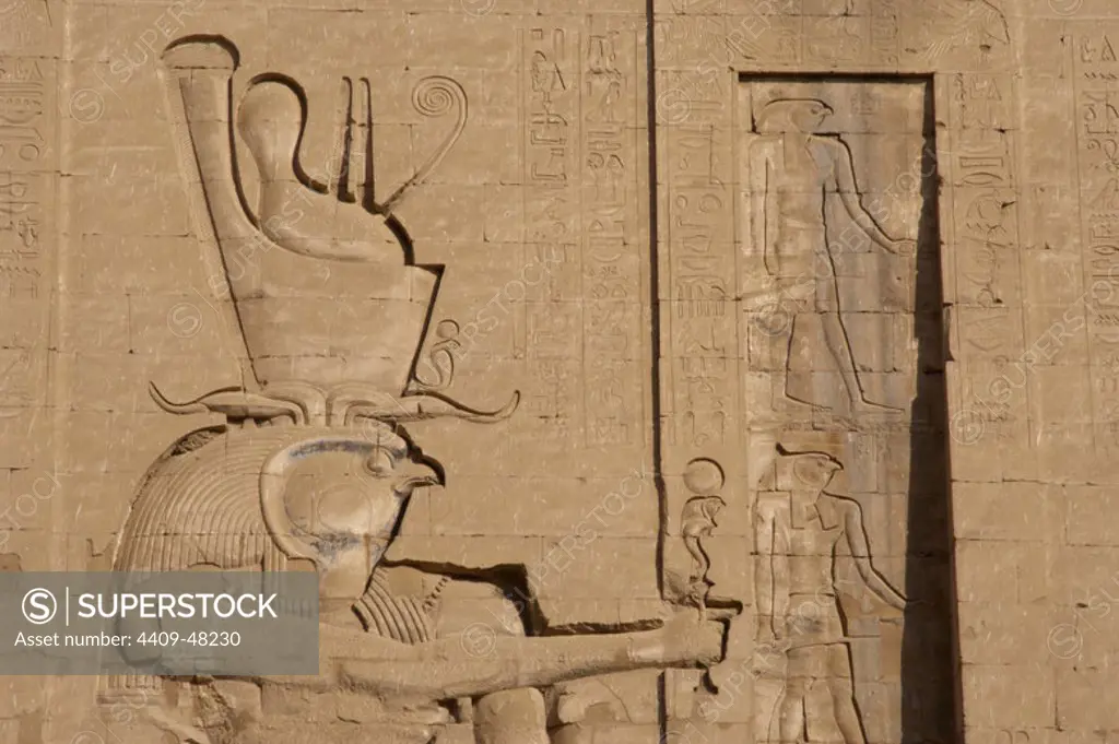 Temple of Horus. God Horus with double crown. Main entrance. First pylon. Detail. Edfu. Egypt.