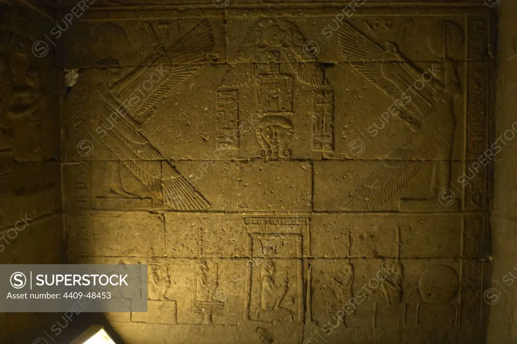 Egyptian Art. Dendera. Hathor Temple. Cult to the goddess Hahtor next to Maat and isis. At the bottom, deity in a shrine. Relief in the high niche at the rear of the Temple.