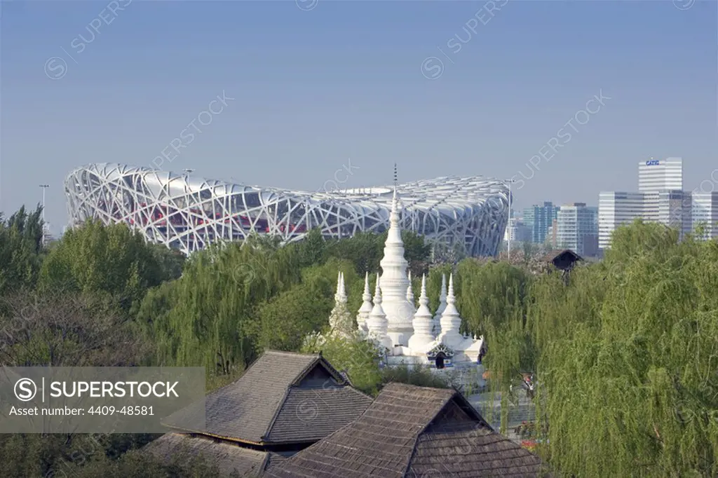 China. Beijing. Chinese Ethnic Culture Park (China Nationalities Museum). At background, the National Stadium (Nao Chao), built for the Beijing 2008 Olympic Games.