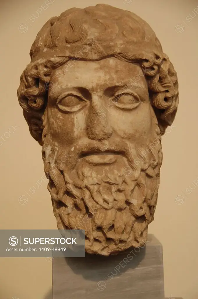 Head of a bearded god in Pentelic marble probably depicting Zeus or Hermes. It seems a work by parian sculptor Euphron. Dated between 450-440 B.C. Eetioneia sanctuary in Piraeus. National Archaeological Museum. Athens. Greece.