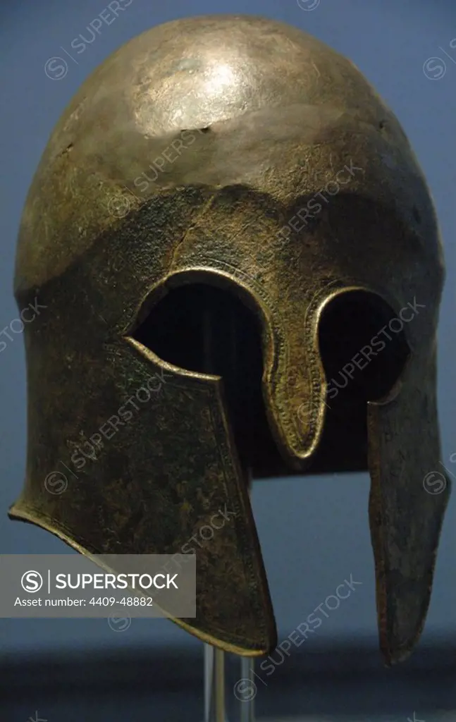 Bronze helmet of Corinthian type. 5th century b.C. Votive offering in the Sanctuary of Zeus by Hieron, tyrant of Syracuse, and his supporters after victory in Cyme (Italy) against the Etruscans in 474 BC Olympia Archaeological Museum. Ilia Province. Peloponnese region.