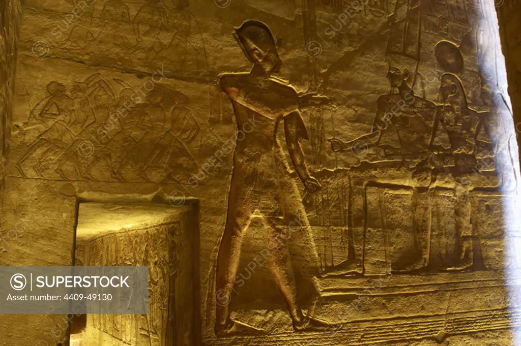 Egyptian art. Great Temple of Ramses II. The pharaoh Ramses II before god Amun.19th Dynasty. New Kingdom.