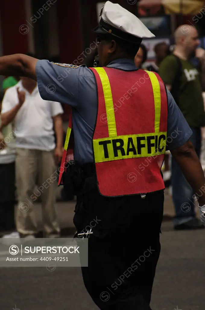 Police agent regulating traffic in Chinatown. New York city. USA.