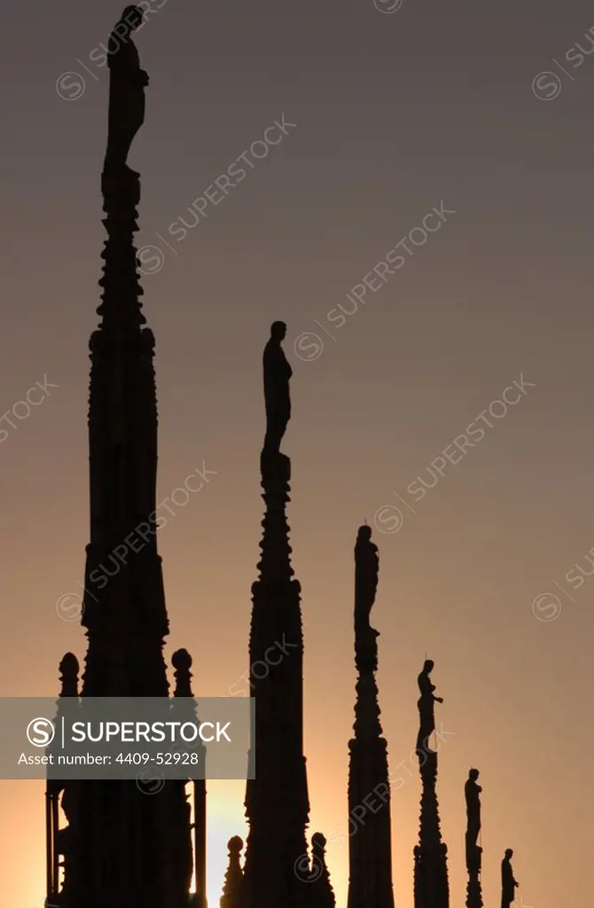 Italy. Milan. Cathedral. Gothic. 14th century. Statues in the spire. Sunset.