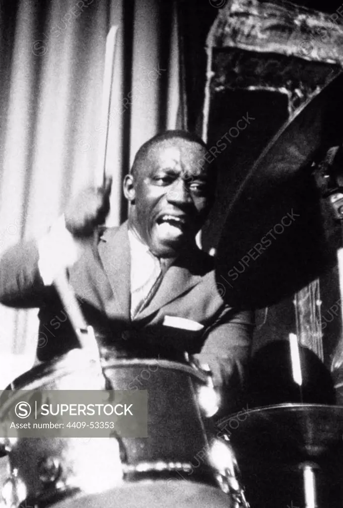 American jazz drummer and bandleader Art Blakey plays a fast figure behind his drum kit during a performance. 1955.