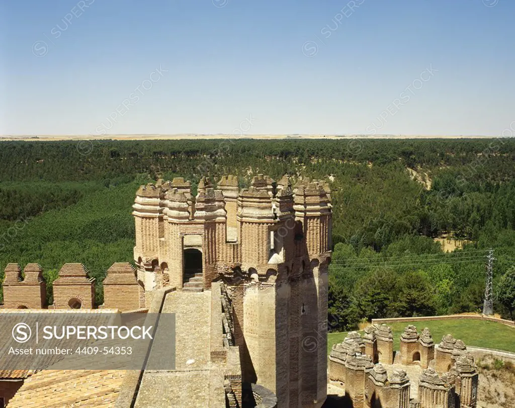 Spain, Castile and Leon, province of Segovia. Coca castle. It was built in the late 15th century by the Castilian magnate Don Alonso de Fonseca. Mudejar style. Battlements of a tower. Architectural detail.