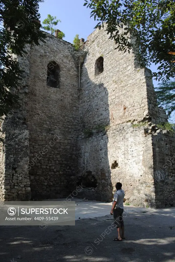 Ukraine. Autonomous Republic of Crimea. Feodosiya. Man looking one of the towers of the Genoese Fortress. 14th century.