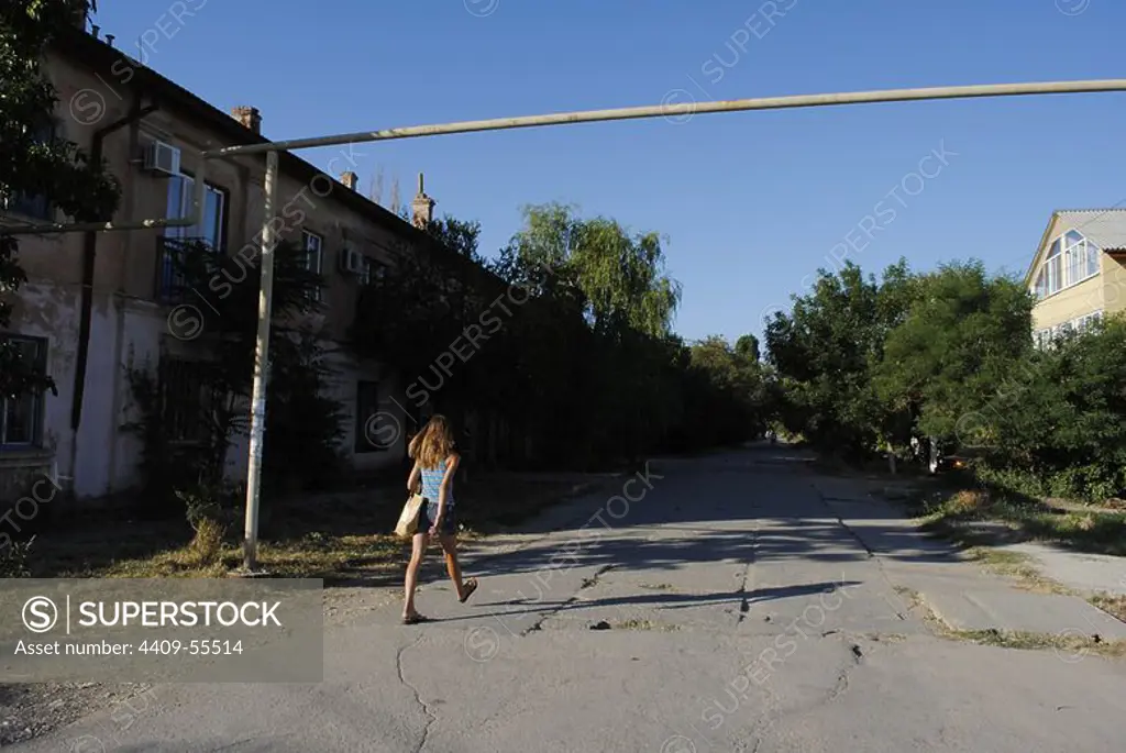 Ukraine. Autonomous Republic of Crimea. Feodosiya. Girl walking along a street.