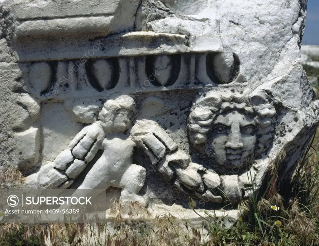 Hierapolis. Ancient city in classical Phrygia, Anatolia. Depiction of a theatrical mask and cupid holding a garland. Fragment of the theater frieze, built in the 2nd century. Turkey.