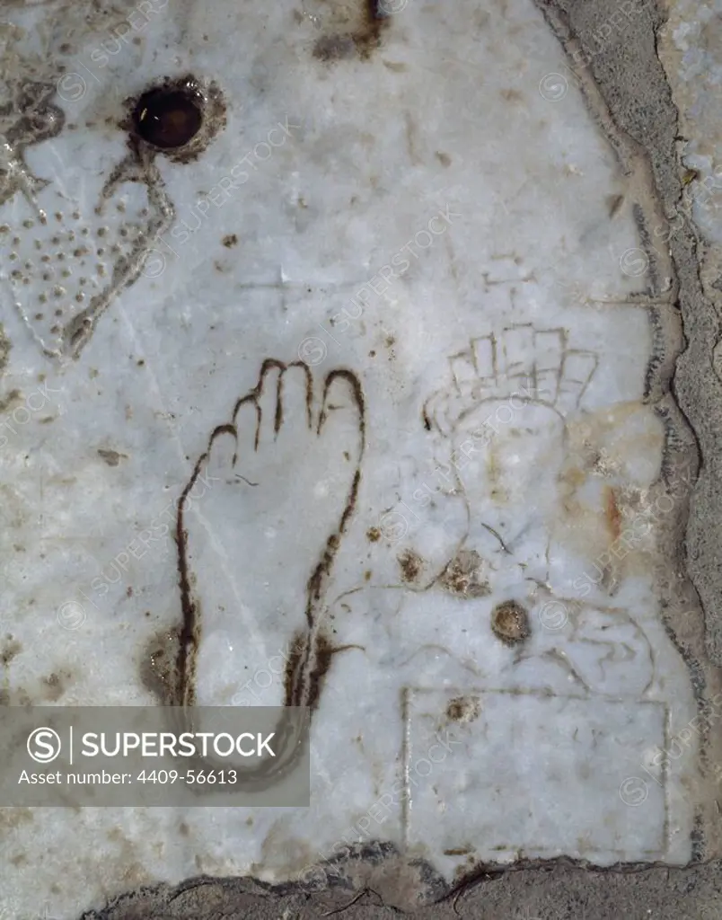 Detail of a marble slab engraved with the drawing of a woman, a left foot and a heart, indicative and symbolism of the close presence of a public house or brothel (lupanare). Marble street. CIty of Ephesus. Roman imperial era. Anatolia. Turkey.