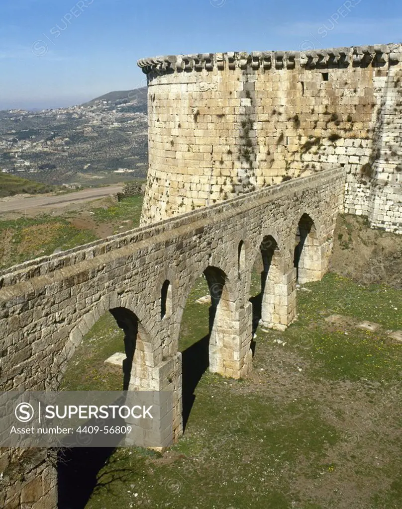 Syria Arab Republic. Krak des Chevaliers. Crusader castle, under control of Knights Hospitaller (1142-1271) during the Crusades to the Holy Land, fell into Arab control in the 13th century. View of the bridge-shaped aqueduct that supplied water to the cistern. Photo taken before the Syrian Civil War.