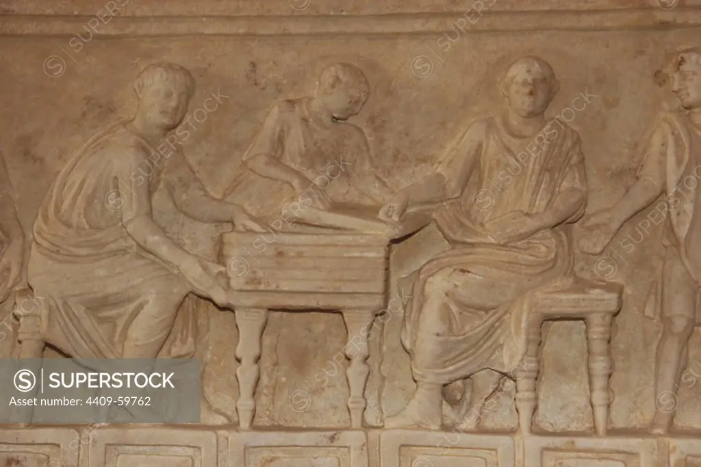 Roman art. Italy. Relief of a sarcophagus depicting a group of freedmen sitting around a table. Museum of the Baths of Diocletian. Rome.